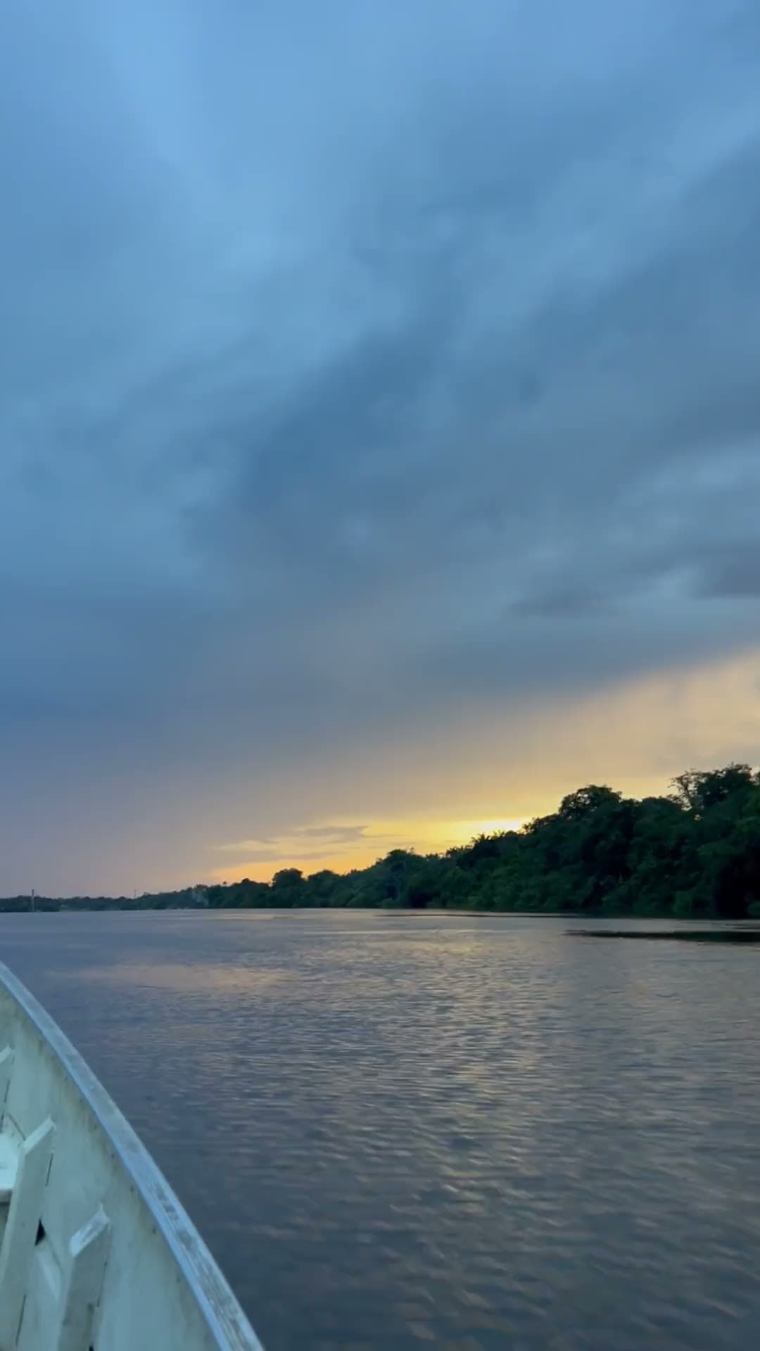 A sunset cruise drifting along the Zambezi River as the sky turns gold