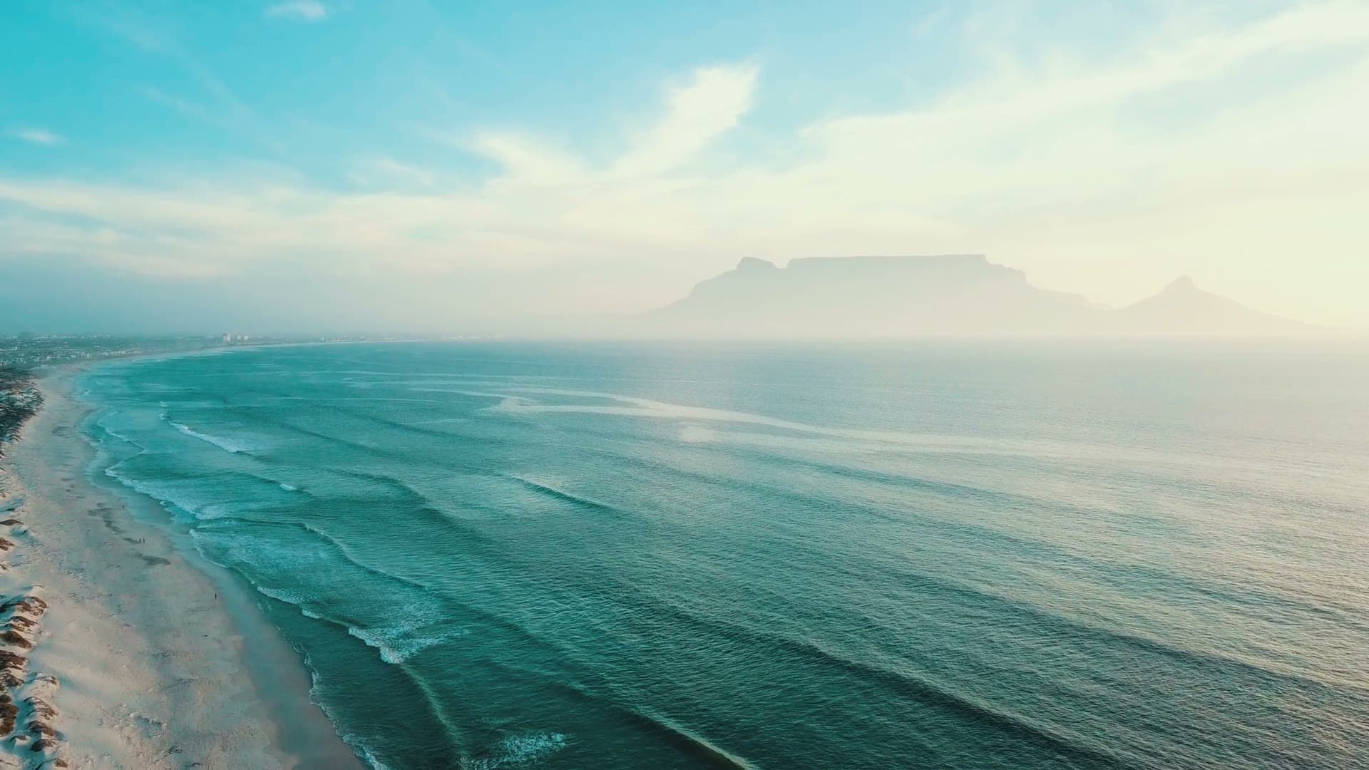 A hazy aerial view of Table Mountain and the Atlantic coastline