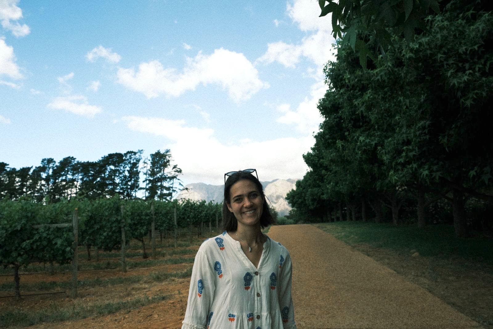 Anni Hoffmann walking through a Cape Winelands vineyard