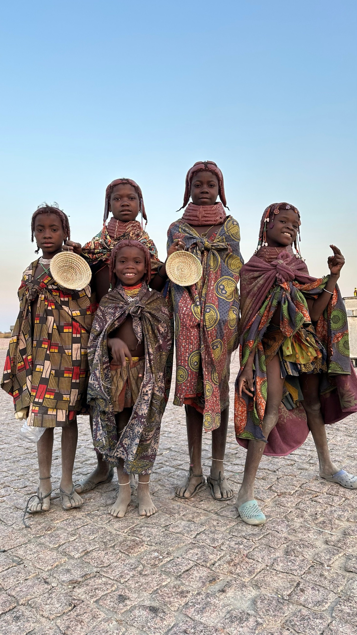 Himba children with traditional ochre-tinted braided hair