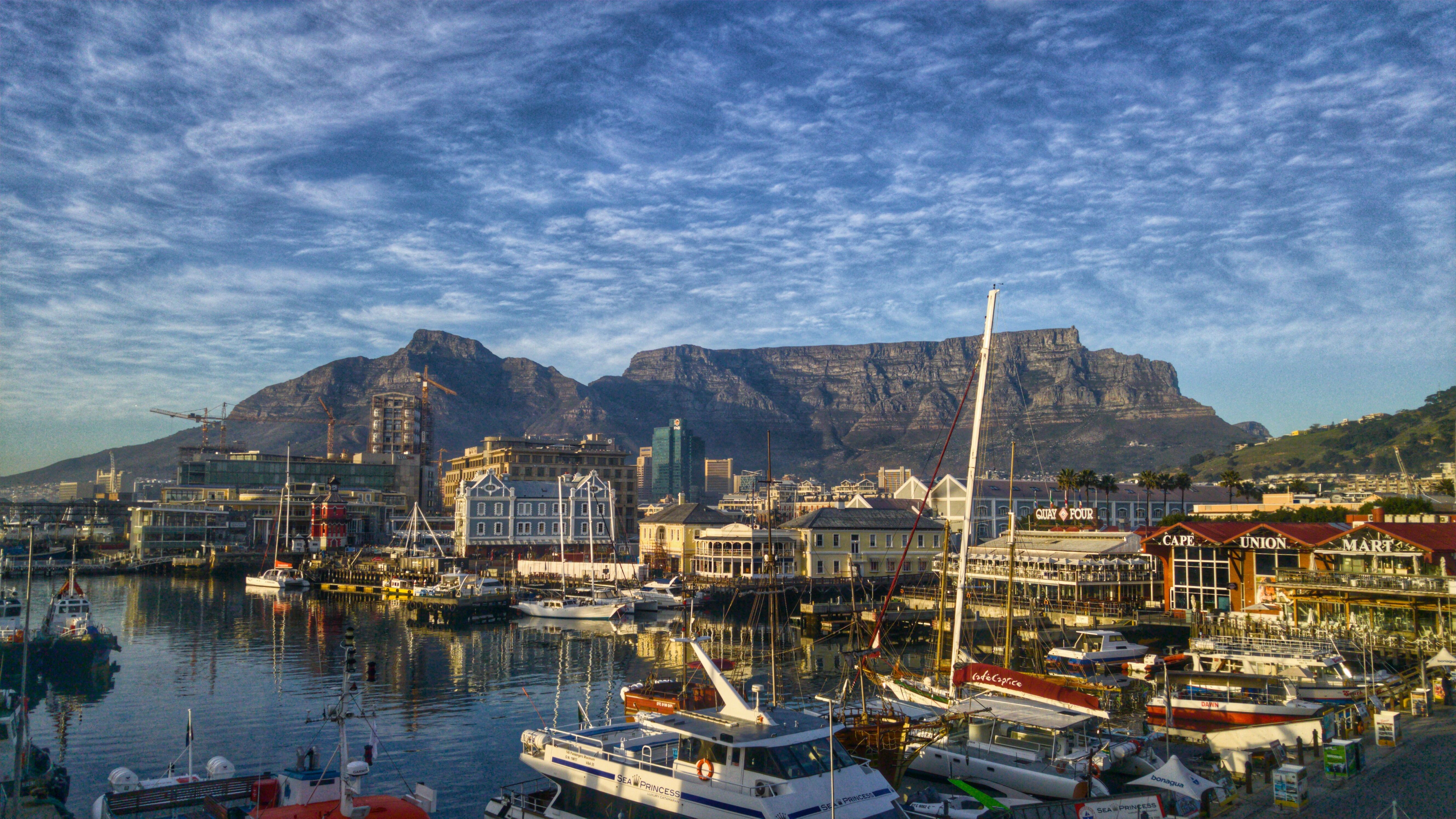 Boats moored at the V&A Waterfront with Table Mountain rising behind