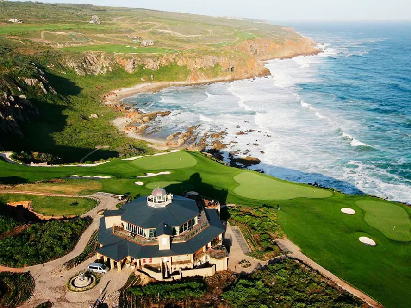 A golf course fairway winding through the Garden Route's coastal hills